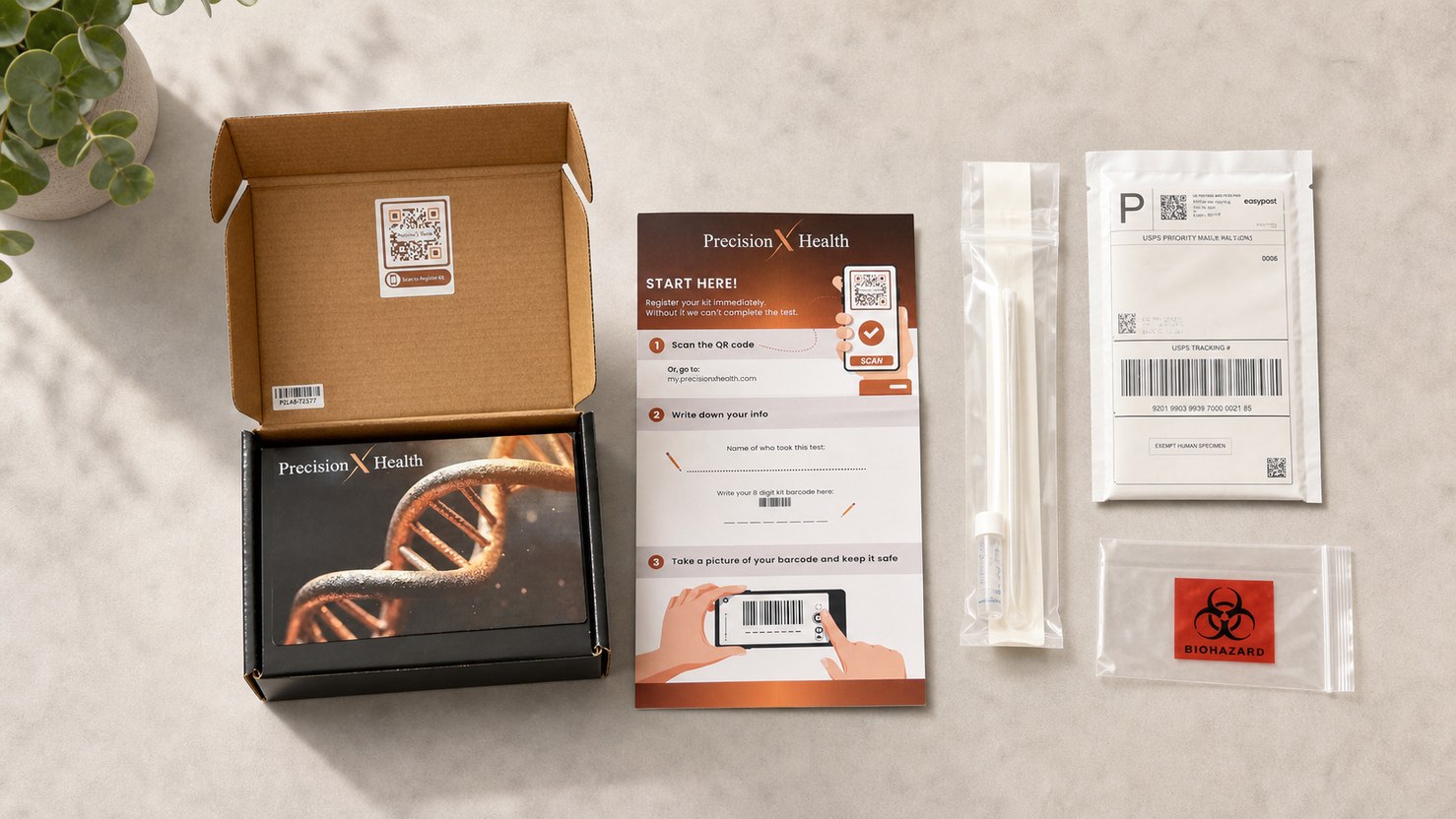 The test kit laid out: box, start-here instruction card, saliva collection tube, biohazard bag, and prepaid return mailer